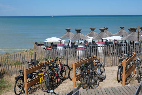 View of ocean with bikes and cafe in Lacanau Ocean