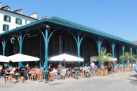 Market hall with restaurants on the banks of the Nive river