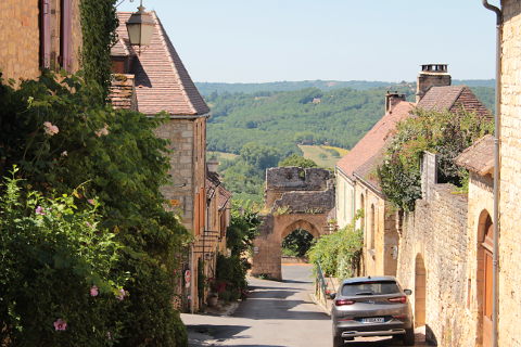 Steep street leading to fortified gate in Domme